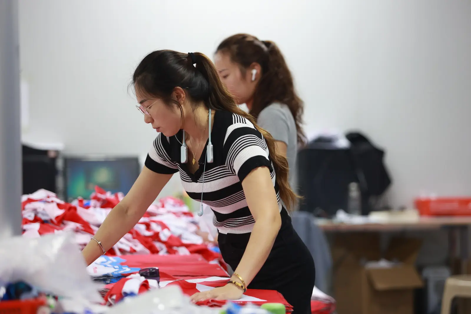 TONTON quality control staff checking finished custom garments