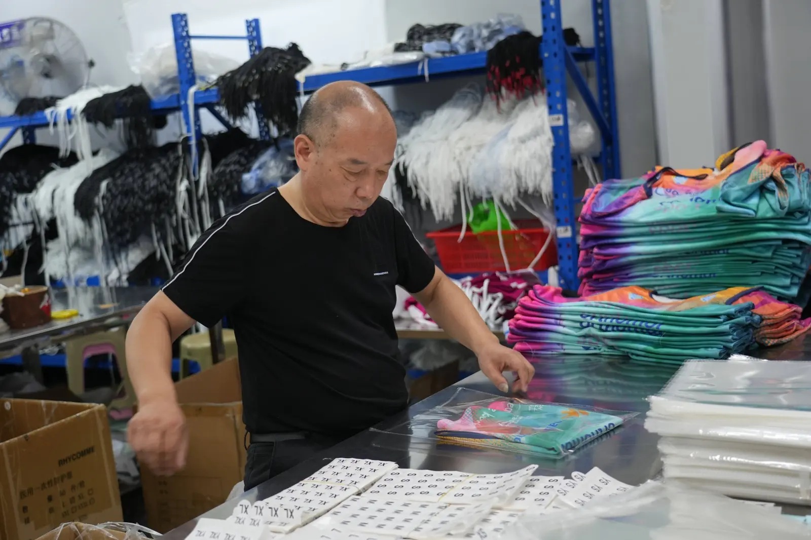TONTON staff folding and packing completed custom sportswear orders